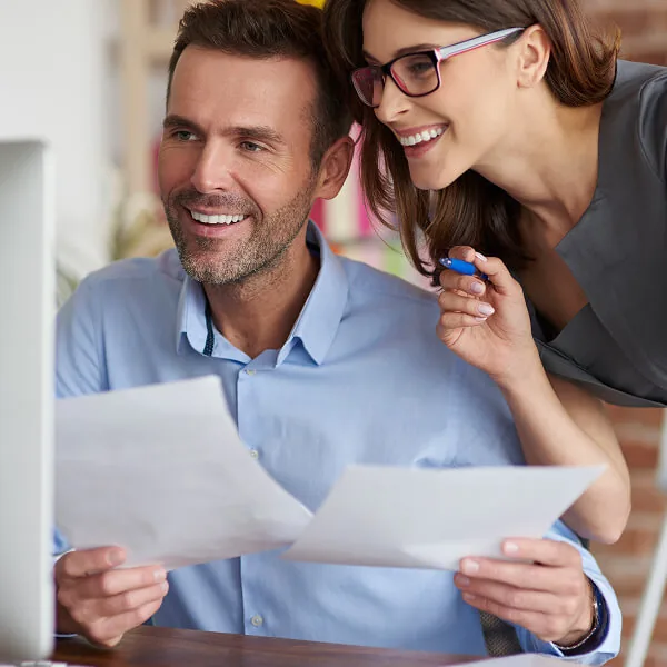Couple reviewing financial documents together while planning a quick loan to cover urgent financial gaps